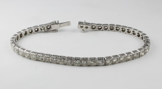 An 18ct white gold diamond tennis bracelet in rub over setting, approx 5.25ct