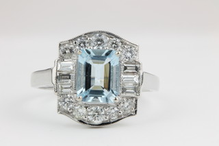 An 18ct white gold aquamarine and diamond cluster ring, the centre stone approx. 1.45ct surrounded by approx 0.9ct of brilliant and baguette cut diamonds