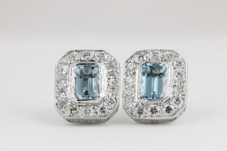 A pair of 18ct white gold aquamarine and diamond cluster ear studs