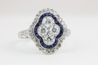 A shaped 18ct white gold dress ring set sapphires and diamonds