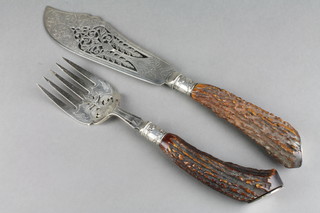 A pair of Edwardian plated, pierced and engraved fish servers with horn handles
