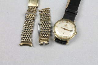 A gentleman's steel cased Omega Constellation automatic wristwatch with calendar dial and leather strap together with  matching gilt metal strap
