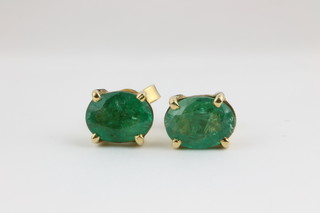 A pair of 9ct gold emerald ear studs with claw mounts