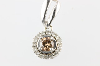 A 14ct white gold diamond pendant, the centre cognac coloured stone surrounded by brilliants