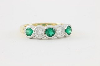 An 18ct white and yellow gold 5 stone emerald and diamond half hoop eternity ring, emeralds approx 0.50ct, diamonds approx 0.47ct