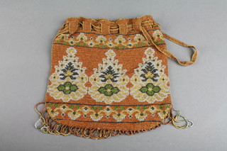 A Victorian beaded purse with formal floral decoration