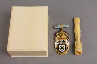 A rectangular ivory box, a carved cigarette holder and an enamelled jewel