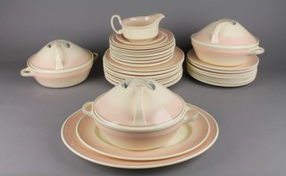 A Susie Cooper part dinner service decorated with stylised feathers comprising a sauce boat and stand (f), 1 side plate (f), 11 small plates (3f), 11 medium plates (3f), 11 large plates (4f), 3 tureens (1f), 3 covers (2f) and 2 oval meat plates 