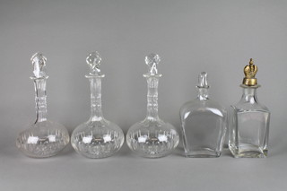 A set of 3 cut glass mallet decanters and 2 others