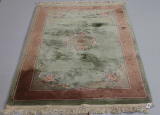 A 1930's green ground and floral patterned Chinese rug 81" x 51" 