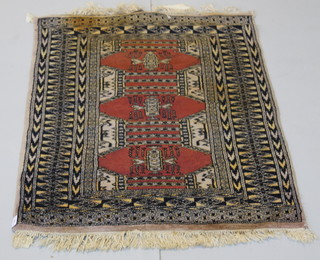 A tan ground Bokhara rug with 3 stylised octagons to the centre 47" x 31" 