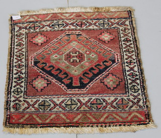 A Persian tan ground rug with diamond to the centre 24" x 21" 