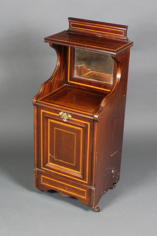 An Edwardian inlaid mahogany coal purdonium, the raised back fitted a bevelled plate mirror 37 1/2"h x 15"w x 13"d
