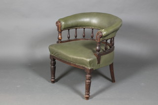 A Victorian mahogany tub back chair with bobbin turned decoration raised on turned and reeded legs upholstered in green rexine