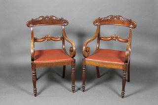 A pair of early Victorian mahogany carved bar back open arm chairs, raised on turned and reeded legs, 1 with old repair to the back 