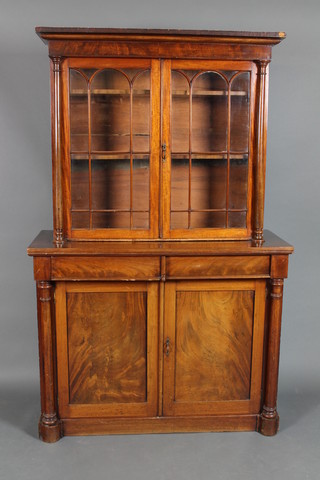 A Victorian mahogany bookcase on cabinet with moulded cornice, fitted adjustable shelves enclosed by astragal glazed panelled doors, the base fitted 2 short drawers above 2 panelled doors and with column decoration to the sides 78"h x 49"w x 20"d