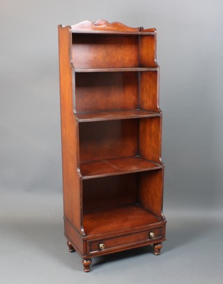 A Georgian style mahogany waterfall bookcase fitted 5 shelves, the base fitted a drawer, raised on turned supports 59 1/2"h x 22 1/2"w x 14"d 