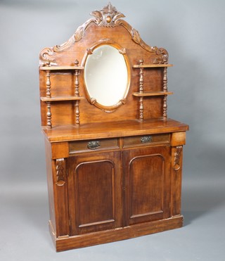A Victorian walnut chiffonier, the raised shaped back fitted an oval plate mirror flanked by 2 shelves, the base fitted 2 short drawers above a double cupboard enclosed by arched panelled doors, raised on a platform base 70"h x 41 1/2"w x 15"d 