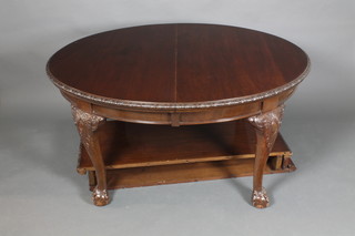 An Edwardian Chippendale style oval mahogany extending dining table, raised on carved cabriole, ball and claw supports with 2 extra leaves 28"h x 55"l closed, extending to 94"l x  47 1/5"w