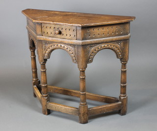 A carved oak 17th Century style Credence table fitted a frieze drawer, raised on turned and block supports 28"h x 33"w x 12 1/2"d