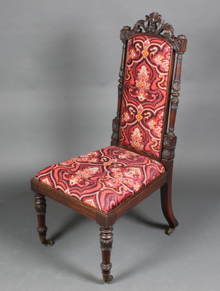 A Victorian carved and pierced rosewood high backed hall chair with upholstered seat and back, raised on turned and fluted legs
