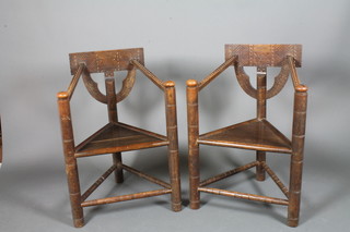 A pair of 19th Century carved oak Turners chairs, raised on turned supports united by a stretcher