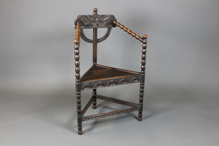 A carved oak Turners chair with bobbin turned decoration 