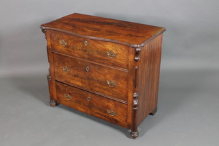 A 19th Century French walnut chest of serpentine outline with quarter veneered top, fitted 3 long drawers with brass escutcheons and stylised turned columns to the sides 34"h x 39"w x 20"d