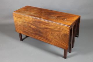 A Georgian mahogany drop flap dining table raised on 6 square tapered supports 27"h x 16"w when closed, x 50" when open, x 48"w