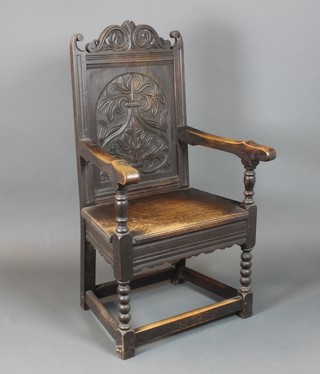 A Victorian carved oak Wainscot chair raised on spiral turned and block supports