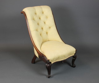 A Victorian carved rosewood show frame nursing chair upholstered in  pink buttoned material on cabriole supports
