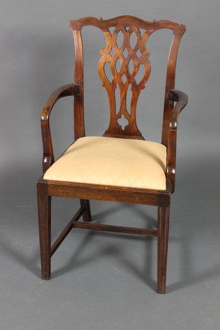 A 19th Century Chippendale style mahogany armchair with pierced vase shaped slat back upholstered drop in seat, on square tapering supports with H framed stretcher,(removed from a ship the base marked First Salon)