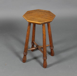 An Art Nouveau octagonal oak stool, raised on turned legs with X framed stretcher 21"h x 12"w x 12"d
