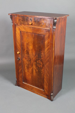 A 19th Century French mahogany cabinet, the shaped top fitted 1 long drawer above a cupboard enclosed by a panelled door with vitruvian scrolls to the sides 49"h x 32"w x 15 1/2"d