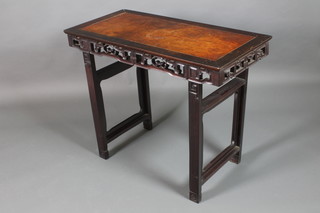 A rectangular Chinese carved Padouk altar table, raised on square supports with carved pierced apron 32"h x 40"w x 19 1/2"d