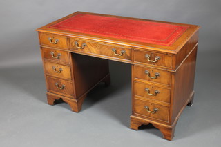 A mahogany kneehold pedestal desk with red inset skiver above 1 long and 8 short drawers with brass swan neck drop handles, raised on bracket feet 29"h x 48"w x 24"d (all in one piece) 