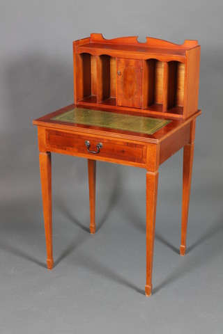 A Georgian style mahogany writing table, the raised back with three-quarter gallery fitted a cupboard enclosed by a panelled door and pigeon holes, having a green inset leather writing surface above 1 long drawer, raised on square tapered legs, spade feet 43"h x 24"w x 21"d  