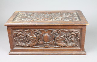 A Victorian rectangular heavily carved oak trinket box with deep carving to the lid and sides, dated 1894 7"h x 15 1/2"w x 8"d 