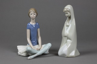 A Lladro figure of a crossed legged seated ballerina 8" and a figure of a kneeling mother and child 8"