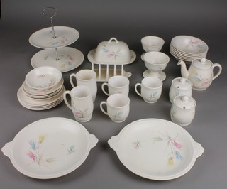A Sylvac Wade tea and coffee set comprising 2 tea mugs, 4 saucers, 3 coffee mugs, 2 preserve pots and lids, a toast rack, a butter dish and cover, 2 bowls, 2 plates, a cake stand, 6 dessert bowls, 4 side plates and a dish