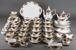 A Royal Albert Old Country Rose coffee and tea service comprising a teapot, coffee pot, 2 cream jugs, 6 coffee cups, 6 saucers, 12 tea cups, 12 saucers, 1 slop bowl, sugar bowl, 2 lidded jars, 4 egg cups, salt and pepper, 2 candlesticks, 12 sandwich plates, a cake stand, dish, bowl, 6 dessert bowls, 6 dishes, an hors d'oeuvres dish and lid 
