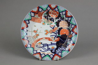 A 19th Century Imari shallow dish decorated with peonies in a geometric border with red 3 character overglazed marks to base 10" 