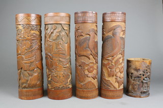 A late 19th Century Japanese carved bamboo pot decorated a pavillion amongst trees 7", 4 similar bamboo vases decorated with birds and flowers 18"
