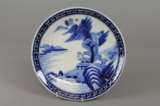 An early 20th Century blue and white Chinese charger decorated with a landscape amongst geometric border 13" diam. 