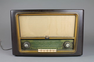 A Philips radio in a brown Bakelite case, the reverse marked MK399
