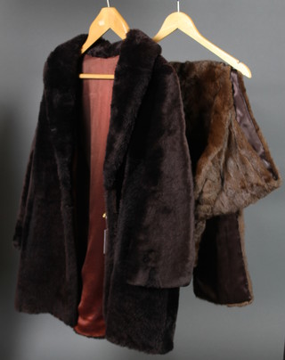 A lady's brown fur coat together with a fur cape