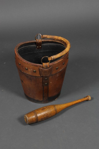 An oval leather hat box converted for use as a stick stand containing a turned Indian club
