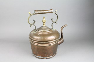 A circular copper kettle with shaped finial 16"