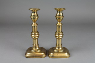 A pair of 19th Century brass candlesticks on square bases 9" 