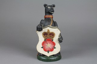 A resin figure of an Elizabethan style seated hound with shield 11 1/2" 